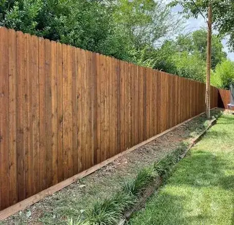 Long wood fence with a landscaped edge