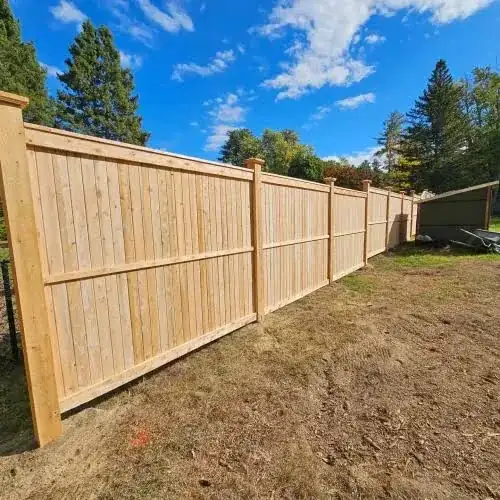 Wood fence with post caps and rails