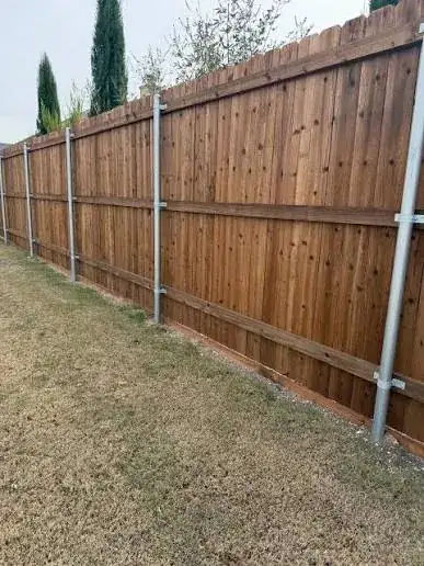 Wood fence on steel posts with stained boards
