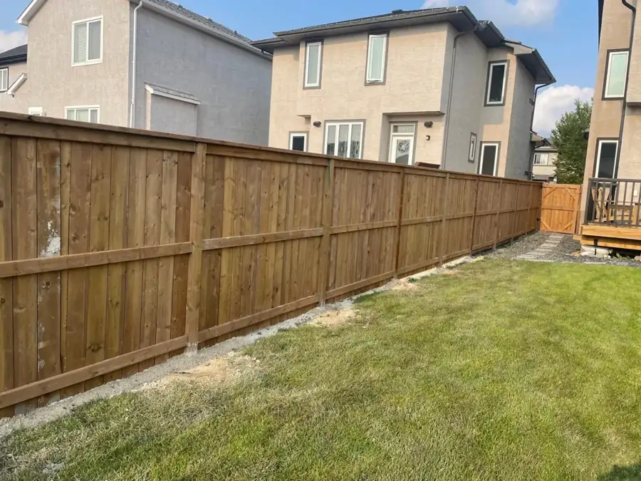 Privacy fence with a gate in a residential yard