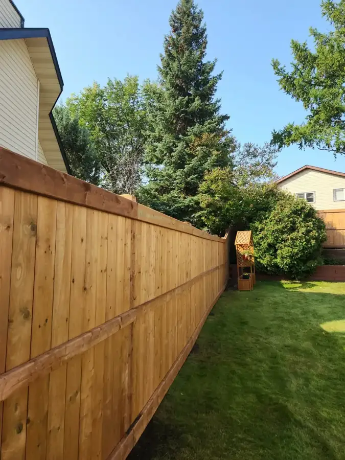 Cedar privacy fence with a top rail